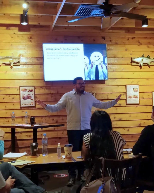 Ray Marfil presentando frente a una pantalla en un taller de ventas